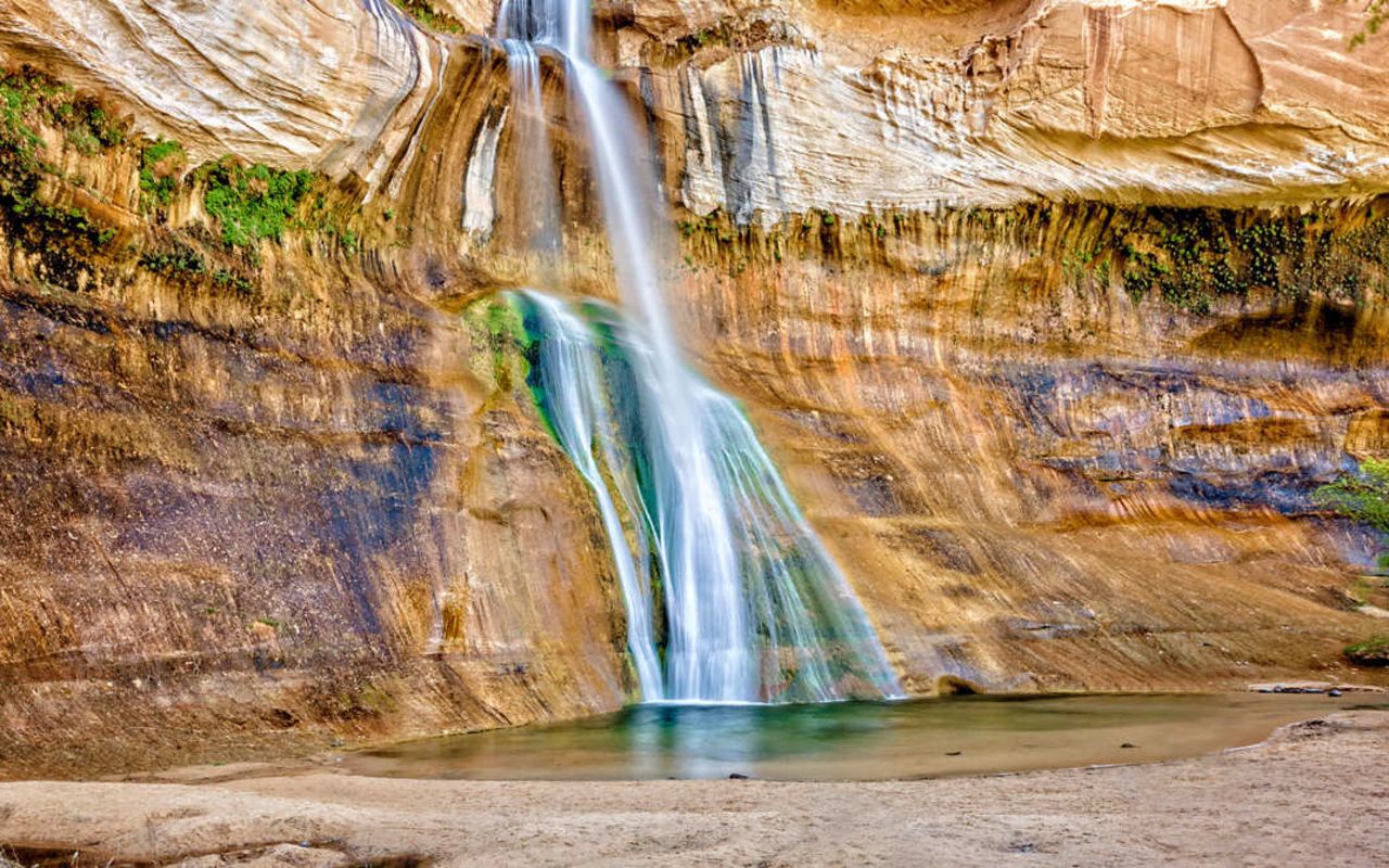 Hikes | Photo Gallery | 1 - Lower Calf Creek Falls drop into a pool with a mossy cliff wall.