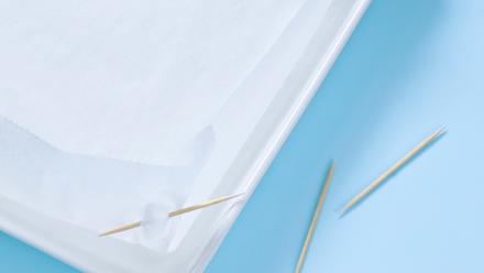 Vinkki! Tee leivinpaperista "vuoka" cocktailtikkujen tai nuppineulojen avulla. Taita paperiin kulmat ja kiinnitä tikuilla. Näin saat sen kokoisen vuoan kuin tarvitset ja pelti pysyy puhtaana.