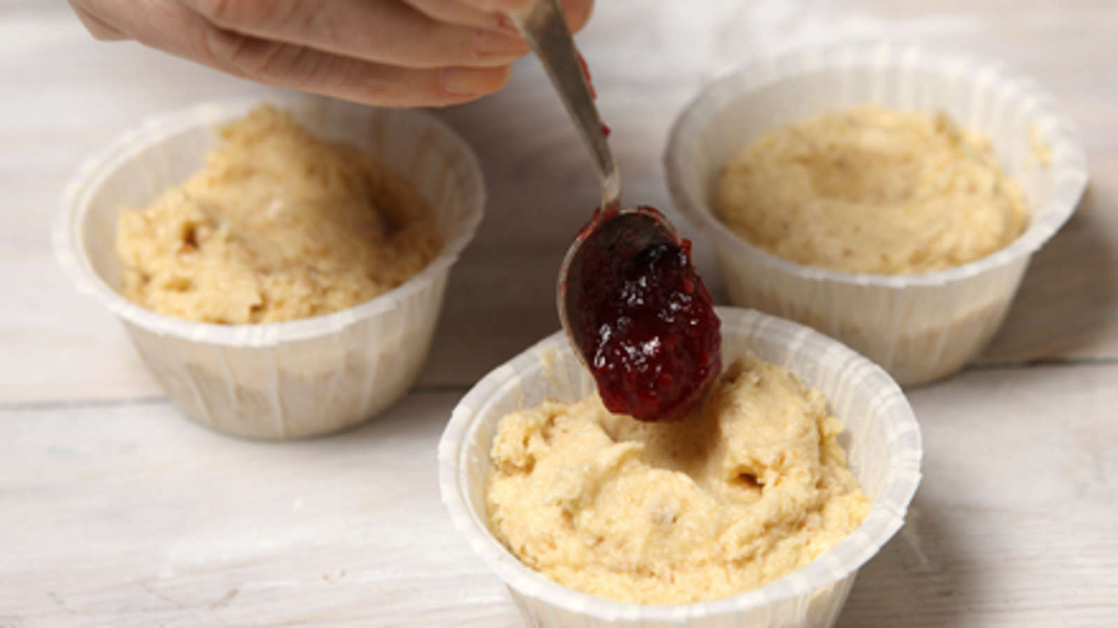 Paina torttuihin kostutetulla sormella syvennys ja pane siihen nokare marmeladia. Kypsennä 200-asteisessa uunissa 13–15 minuuttia. Anna jäähtyä jairrota leivonnaiset vuoista (paperimuotteja ei välttämättä tarvitse irrottaa).