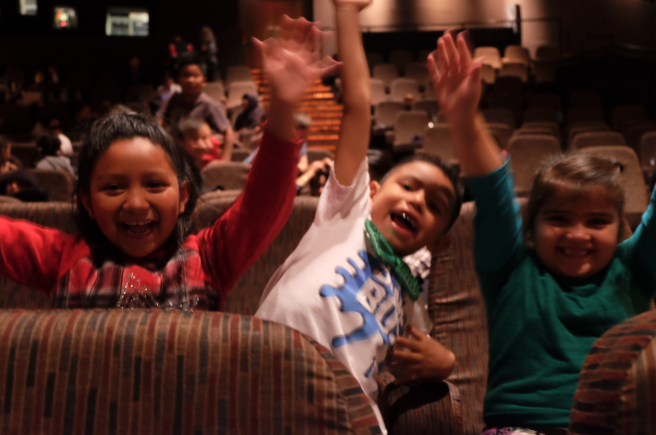 Students pretend they’re on a roller coaster in the Paramount Pictures theater.