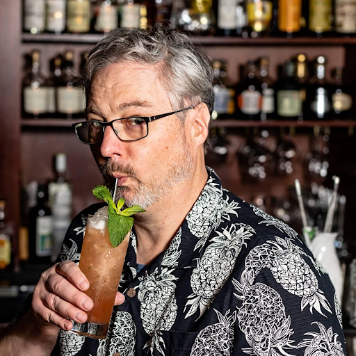matt drinking a cocktail at a bar