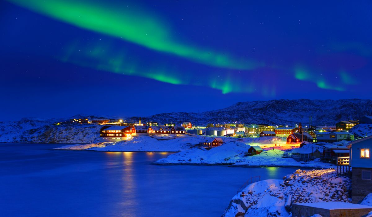 Northern lights or aurora borealis above city Ilulissat, Greenland, Arctic