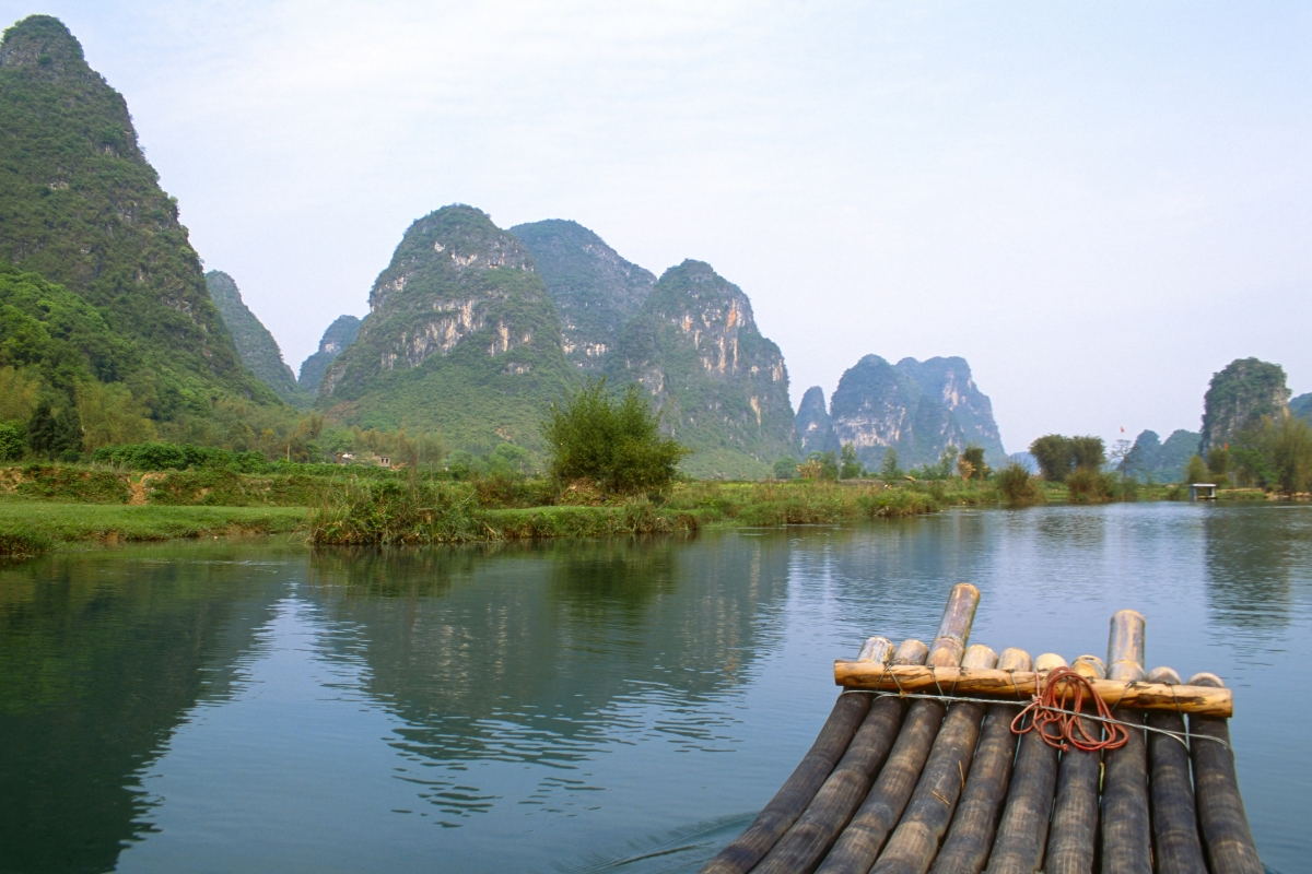 Experiencing the Yulong River by bamboo raft.