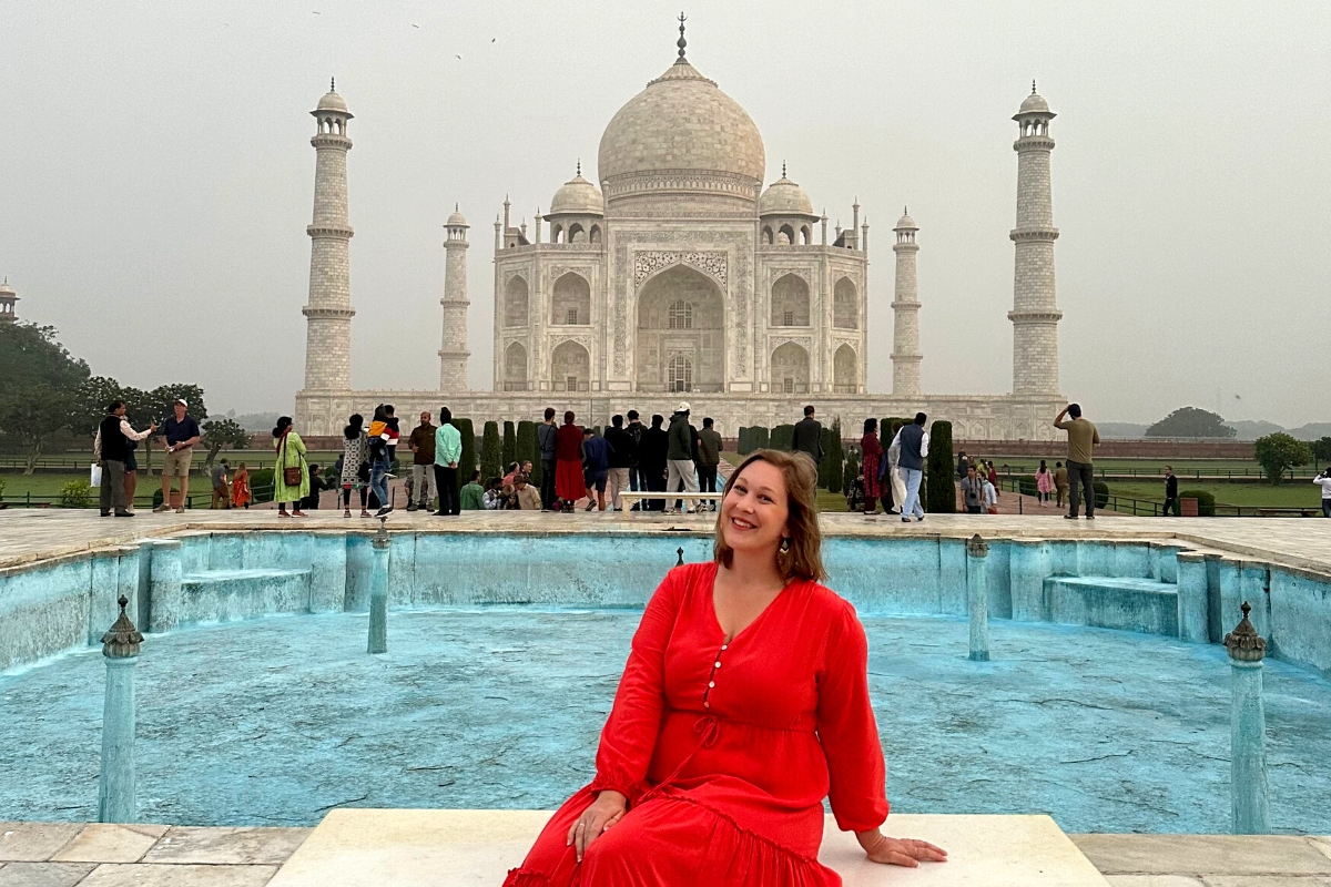 SA Expeditions Destination Expert Jackie Becker sitting at the Taj Mahal, Agra, India