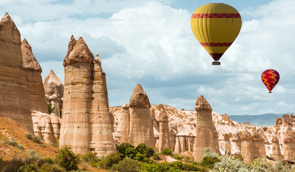 Fairy chimneys hoodoo rock formations and hot air balloons in Cappadocia, Turkey