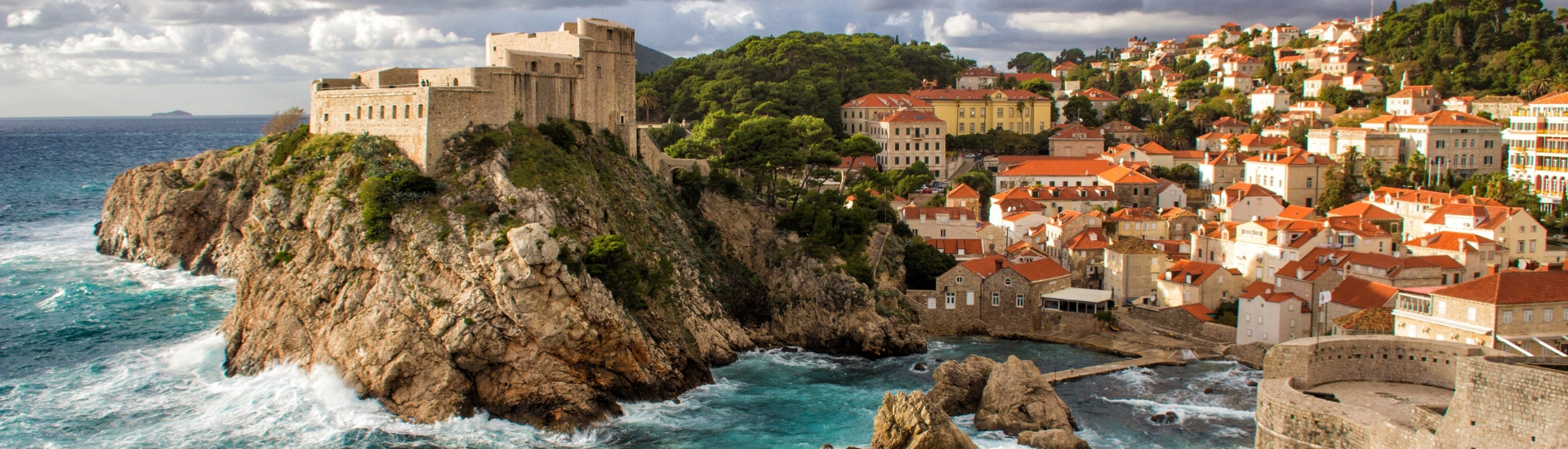 Waves crashing at rocky cliffs on coast of Dubrovnik, Croatia