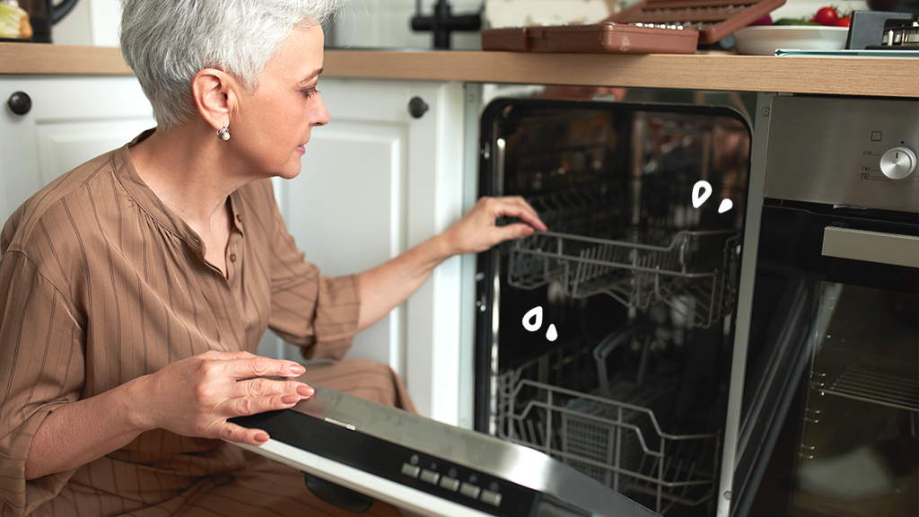 Woman looking into dishwasher that's not filling with water