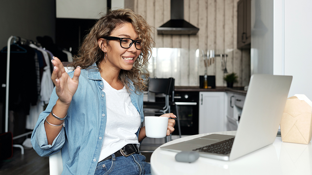 Woman using MacBook camera for video chat