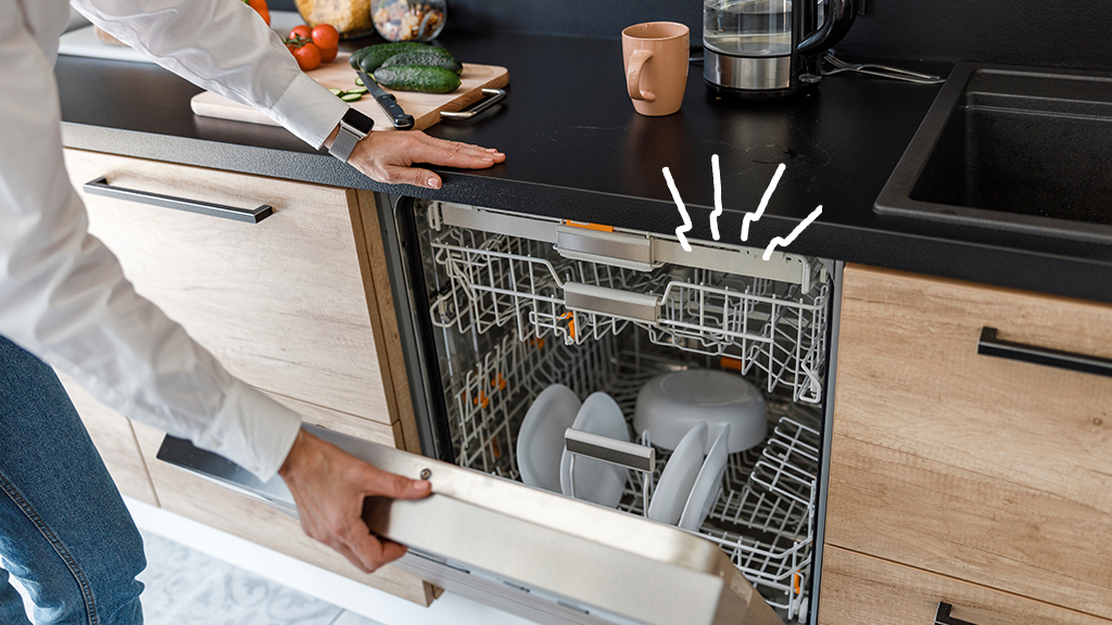 Person looking into dishwasher to discover why it's making noise