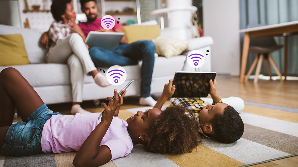 Family relaxes with multiple devices connected to home internet.