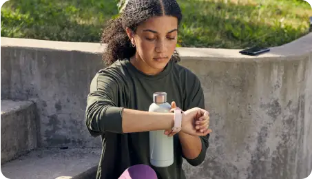 Woman checkers her smart watch