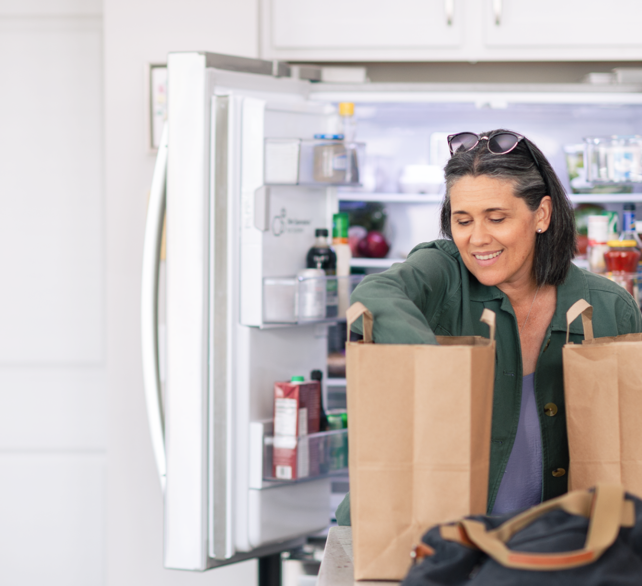 Woman using repaired refrigerator