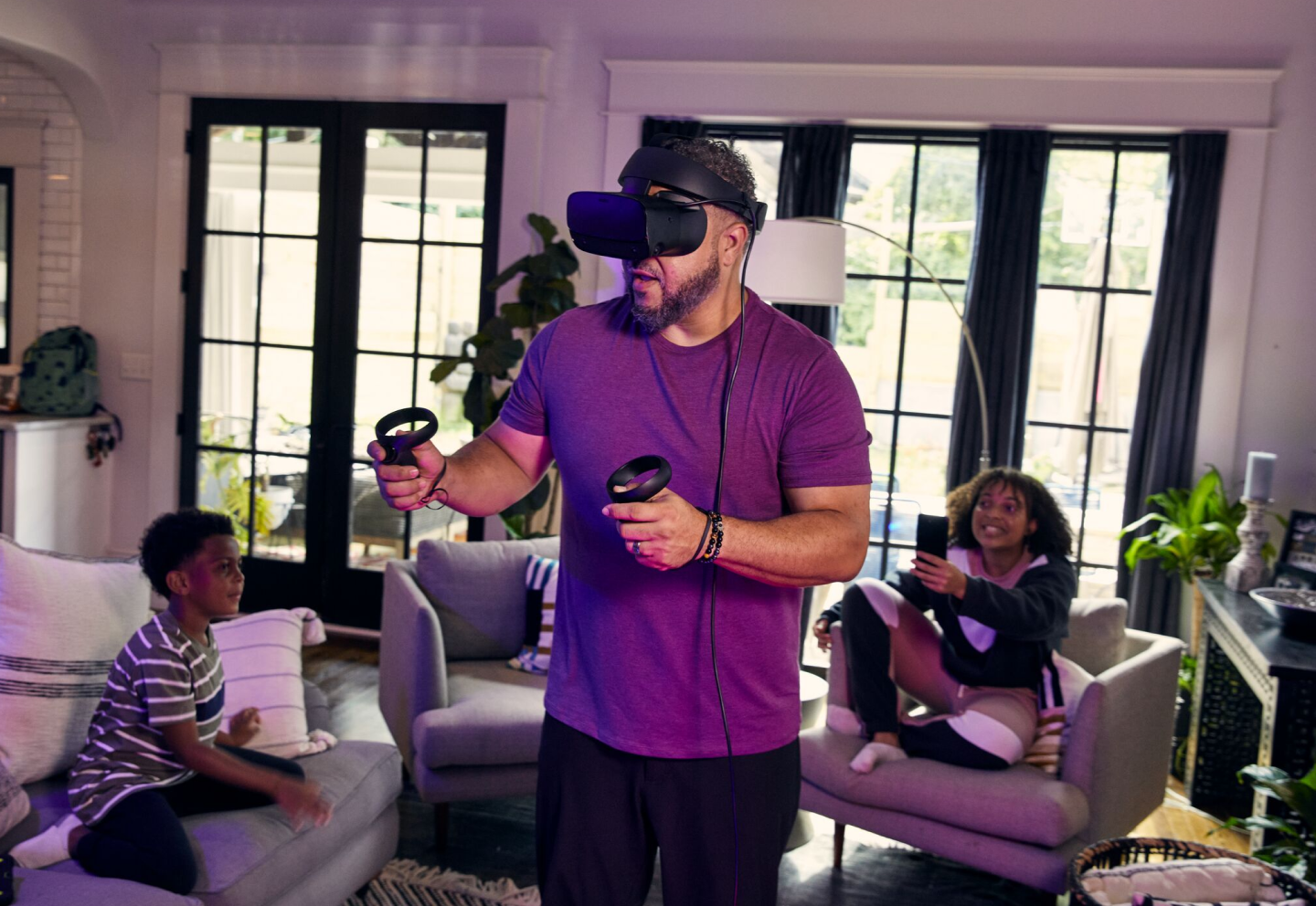 Man using VR headset while the kids watch
