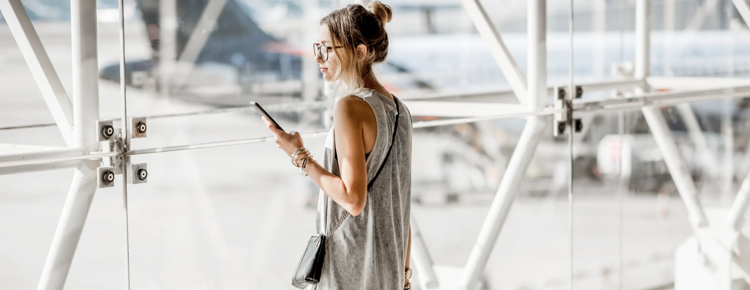 Woman using phone in airport