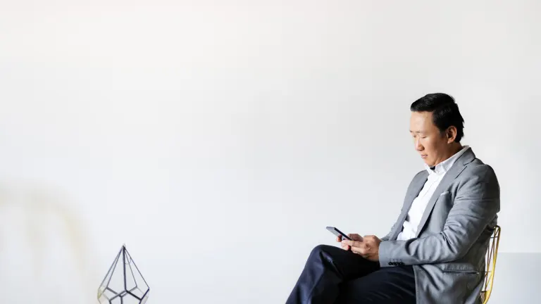 Business man looking at a phone