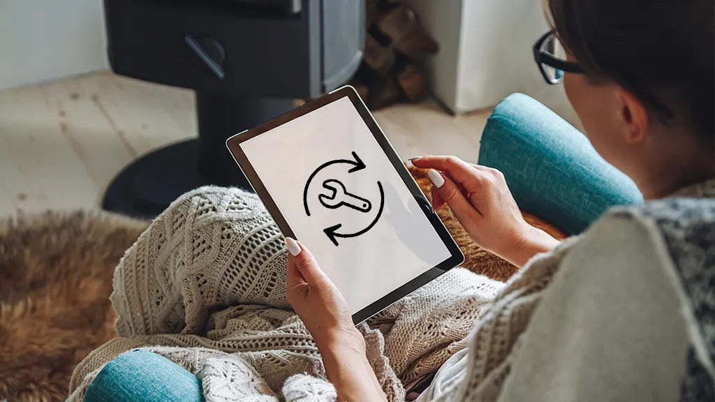 Woman sitting in a chair resetting her Fire tablet