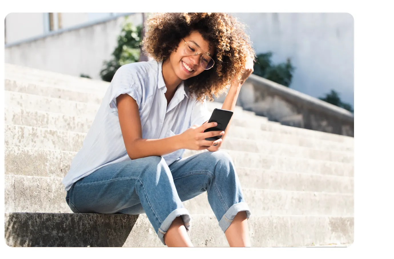 Woman using phone on steps