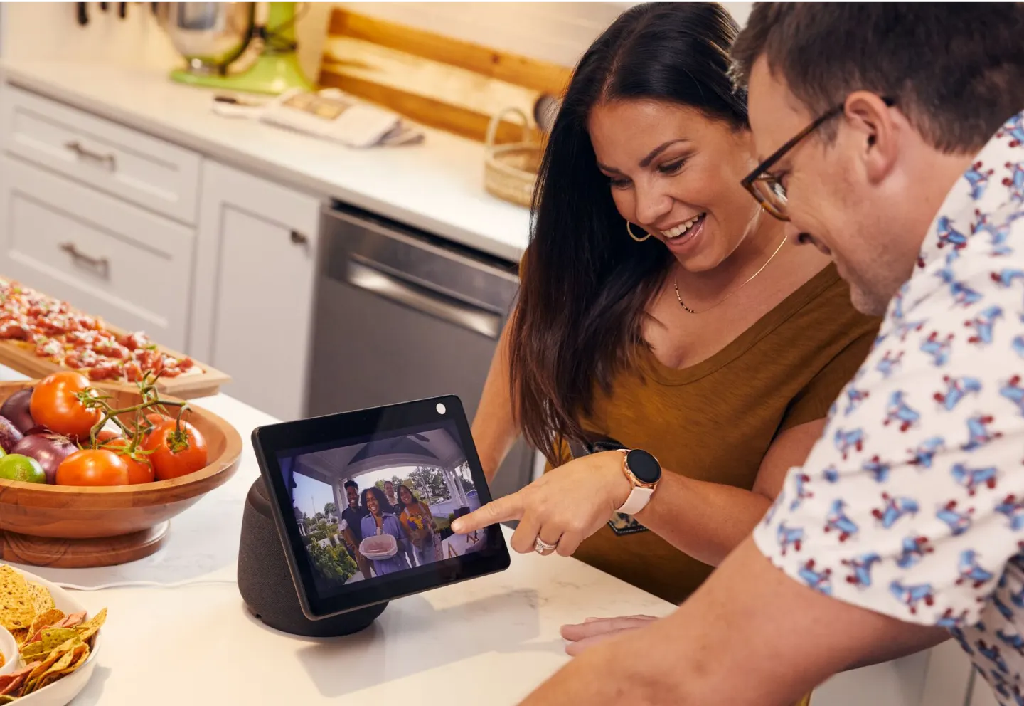 Couple using tablet to view doorbell camera