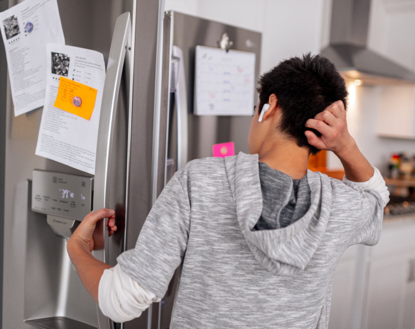 Teenager looks in the refrigerator 