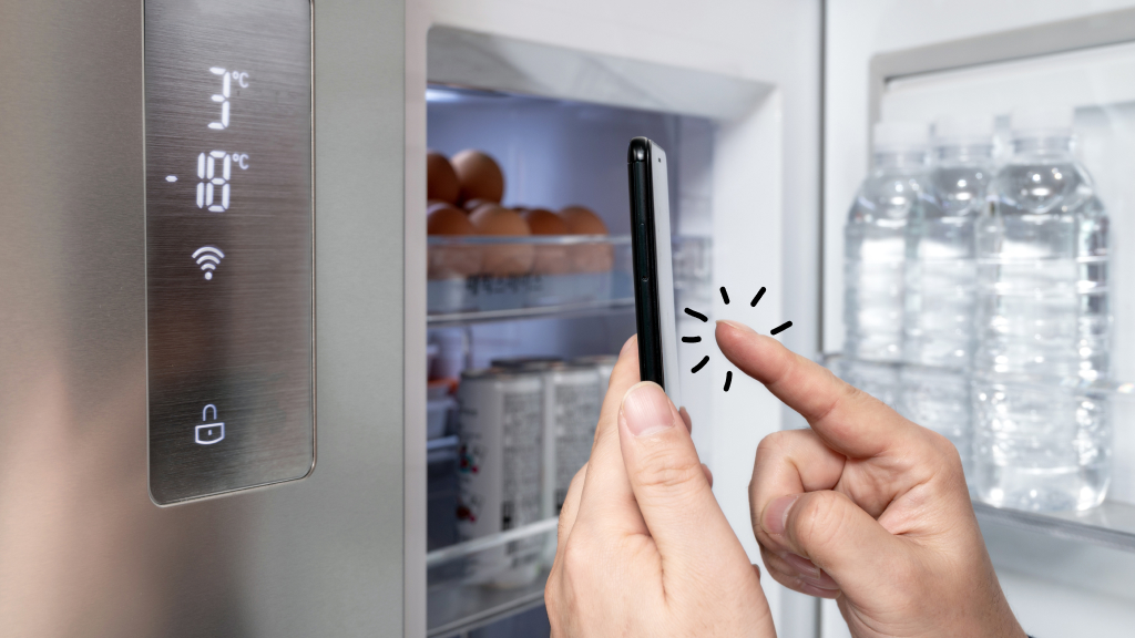Person using smartphone to control smart fridge