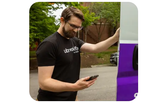 uBreakiFix by Asurion technician looking at his phone