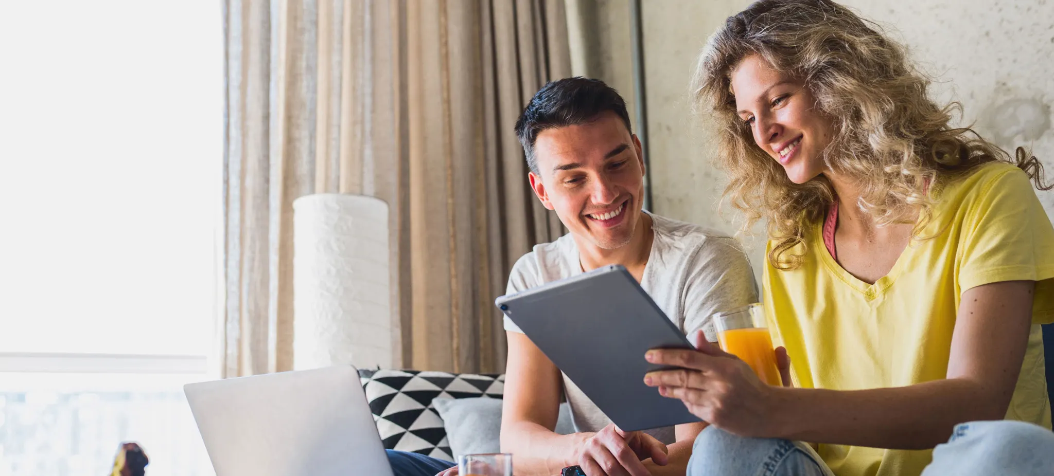 a couple looking at a tablet
