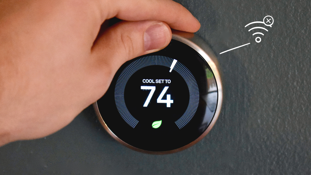 Person's hand adjusting Google Nest thermostat that won't connect to Wi-Fi