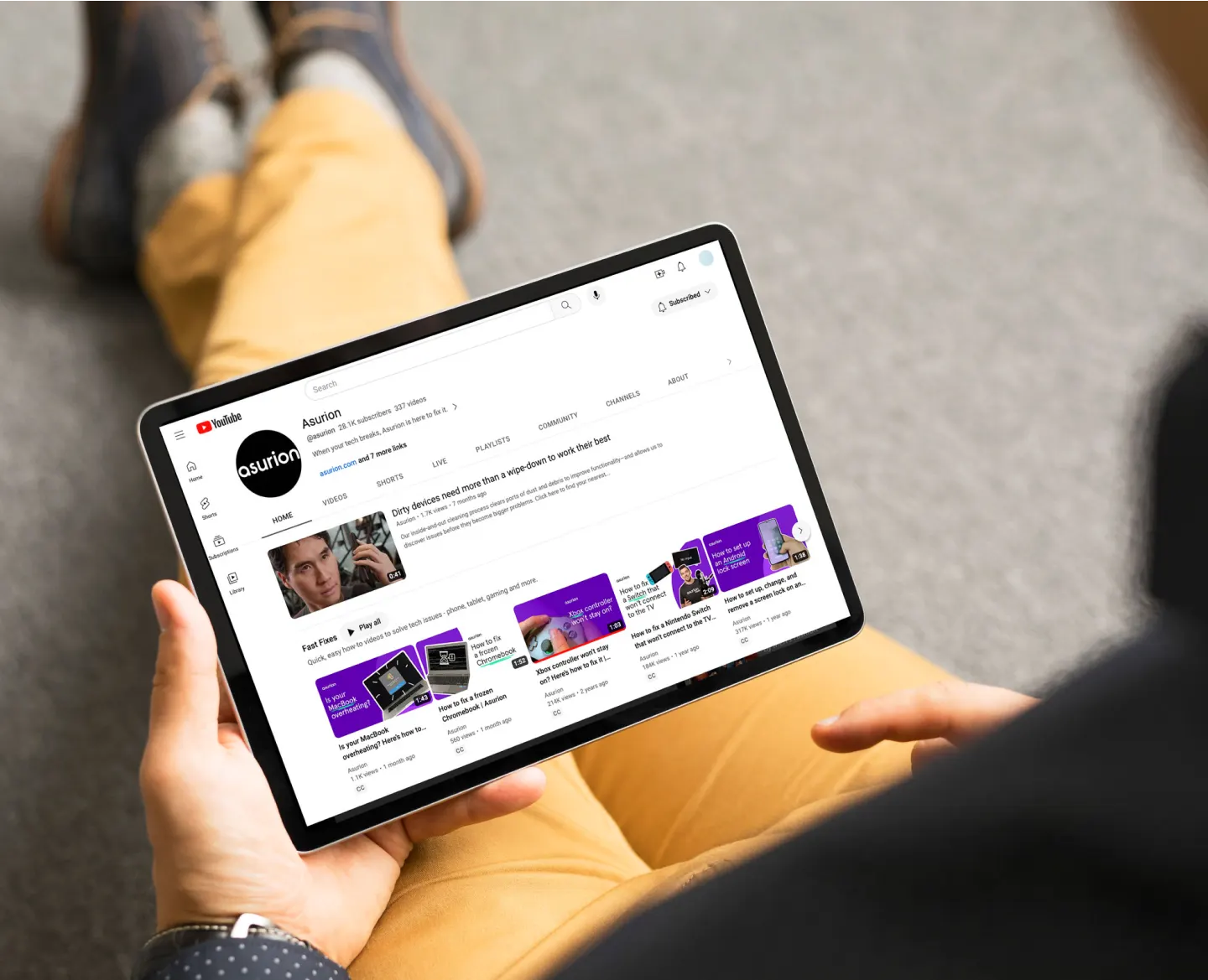 A tablet being held while the user sits