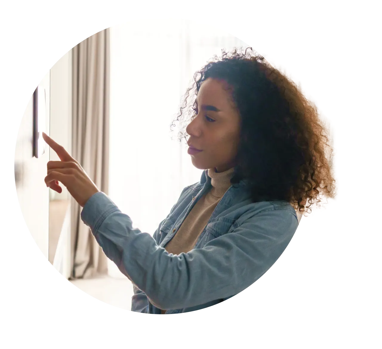 Woman using smart thermostat