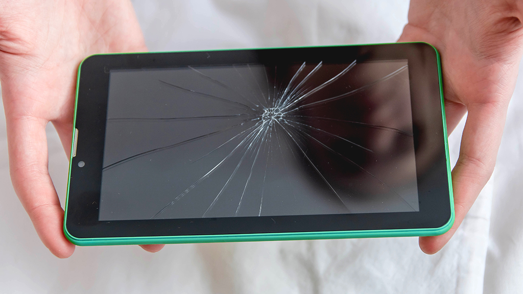 Person holding cracked tablet screen