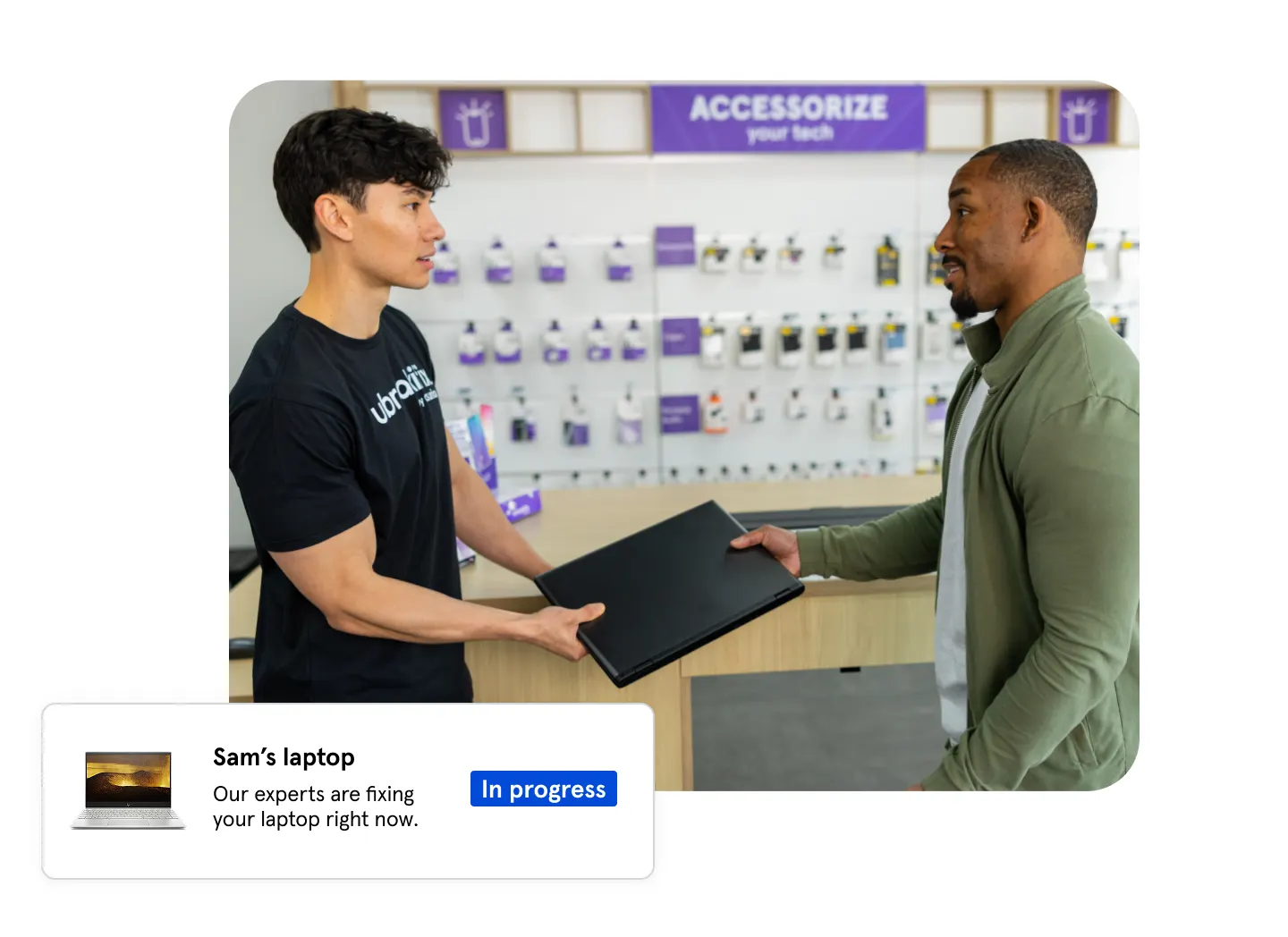Technician assisting customer with laptop at repair store with status showing repair in progress.