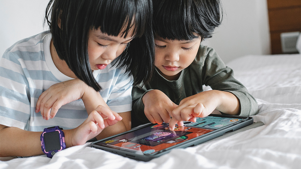 Young children using tablet online