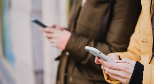 two women using their phone