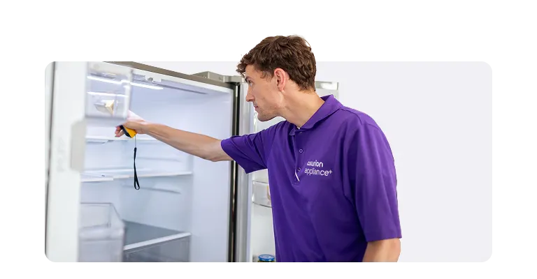 In-home service appliance+ tech checking fridge