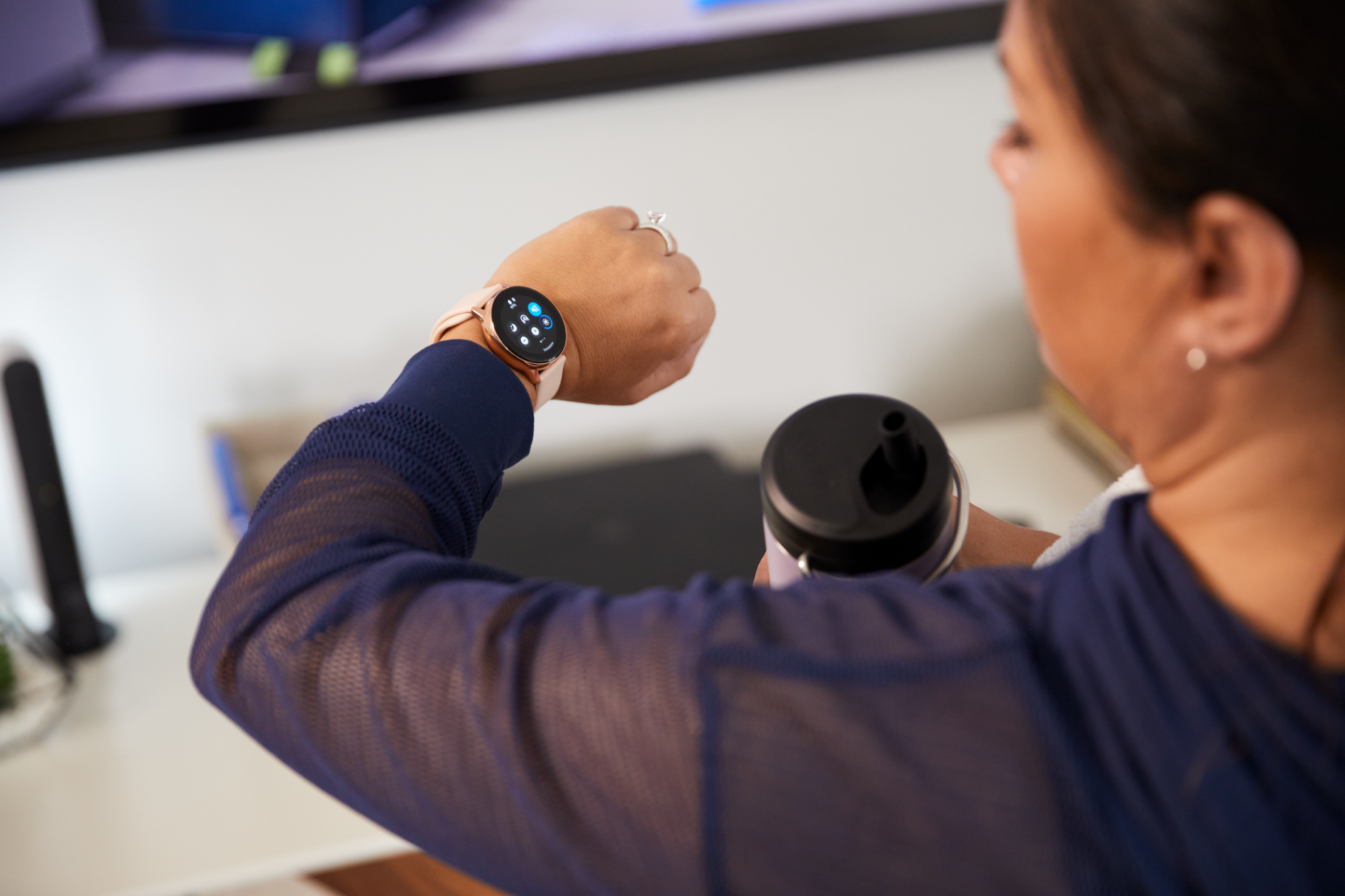 Woman looking at her smart watch on her wrist