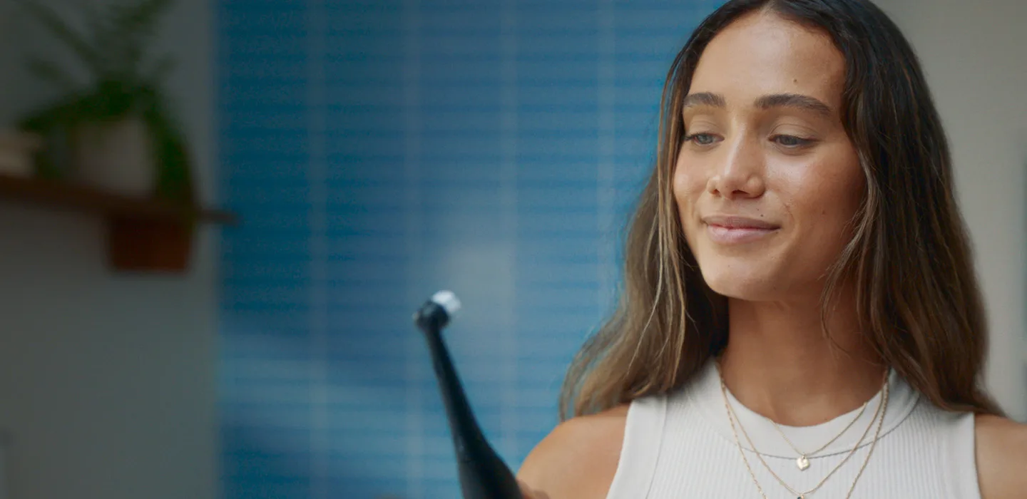 Lady with electric toothbrush