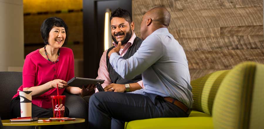 two people talking in library with laptop