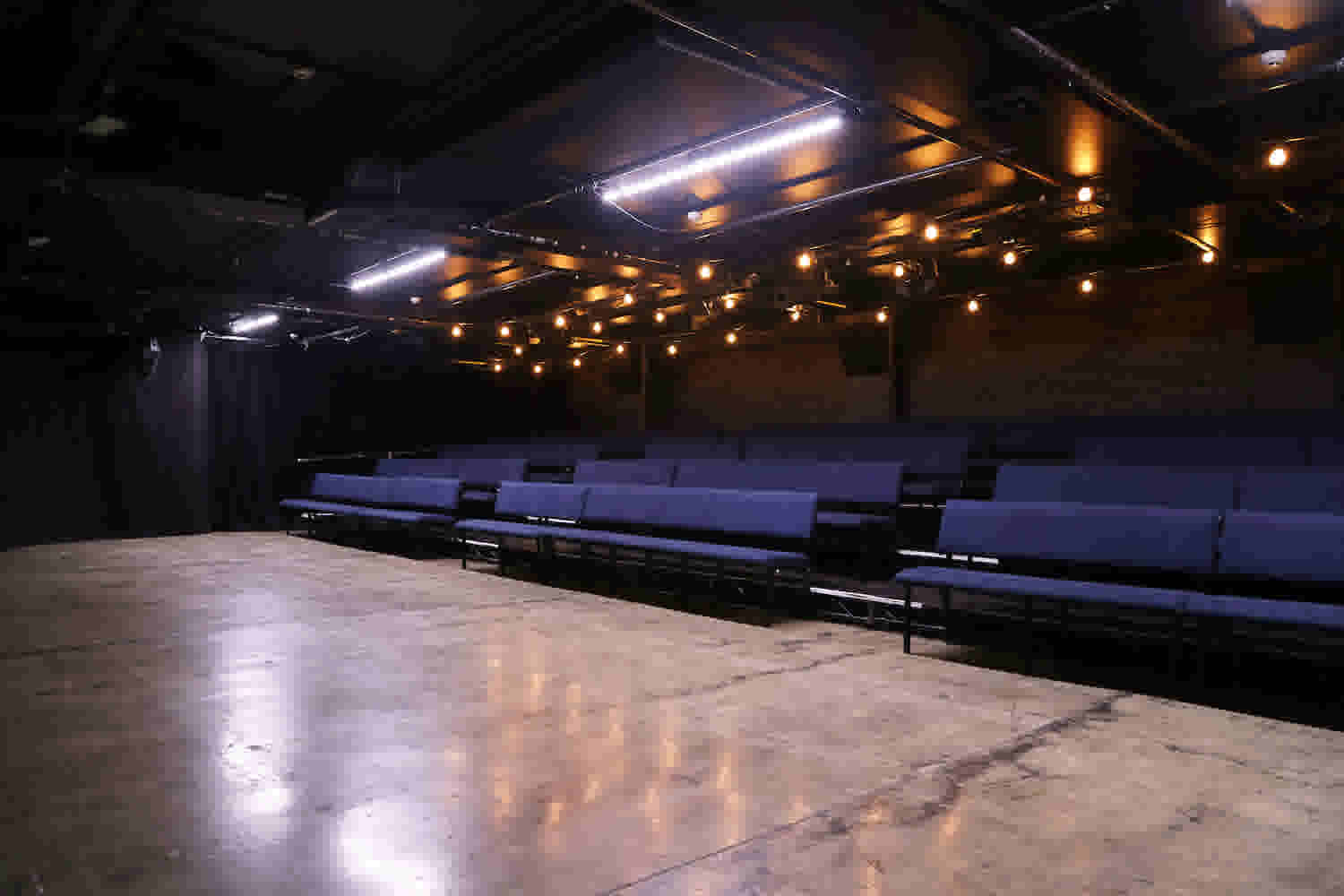Basement Theatre's main Theatre space showing the stage and seating block as you come in the main entrance. 