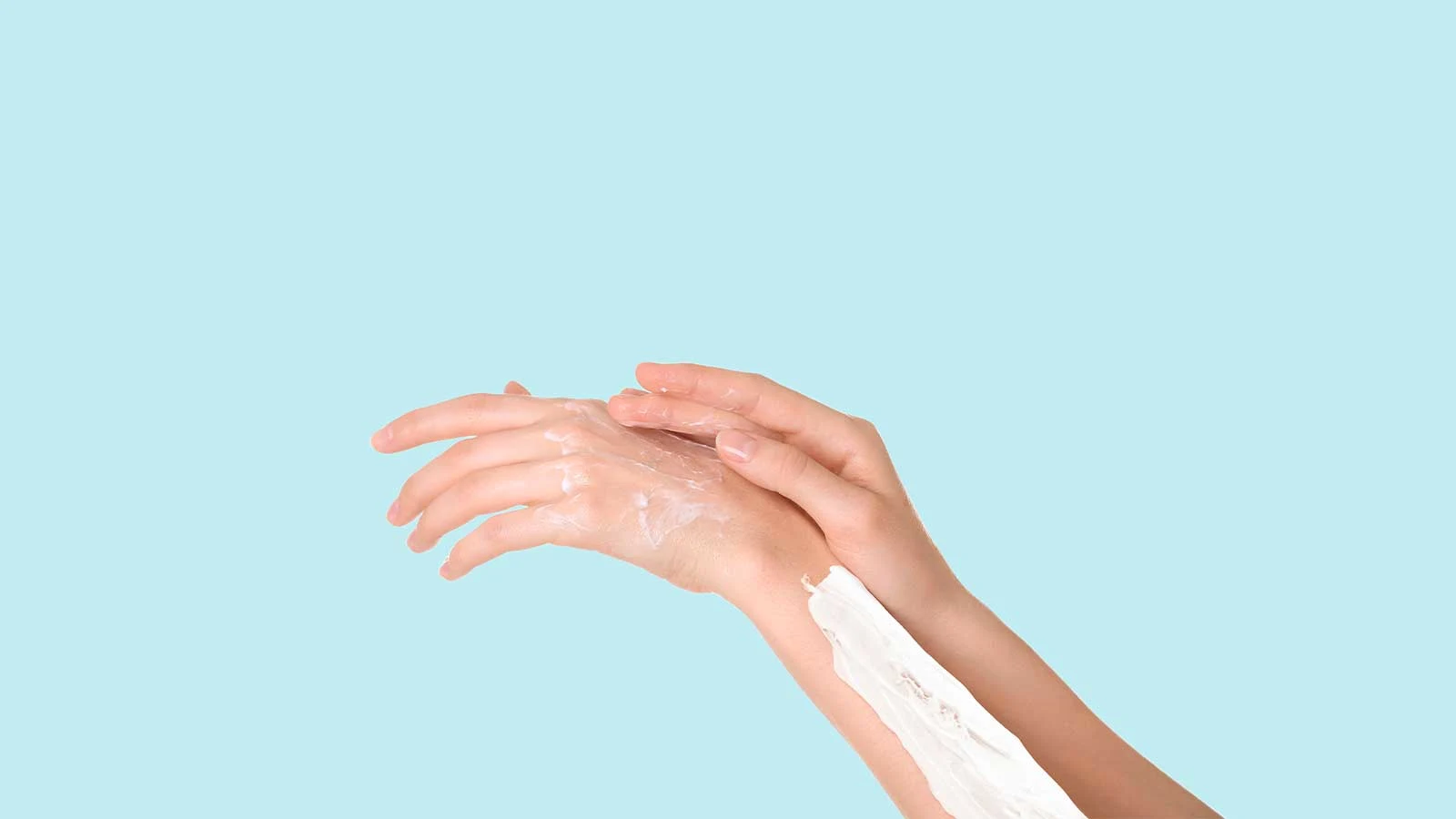 Female arms covered in cream