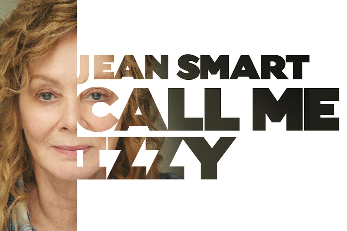 A promotional image featuring half of a woman's face with curly hair, overlaid by bold black text that reads "Jean Smart Call Me Izzy" against a white background.