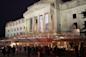 People outside the Brooklyn Museum exterior at night in Brooklyn, NYC