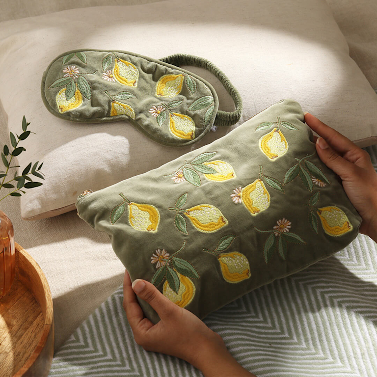 An Elizabeth Scarlett green velvet pouch with a lemon pattern