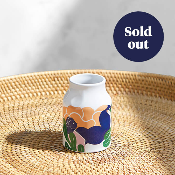 A small Kelly Anna vase sits on a wicker table. A label over the image says 'Sold out'