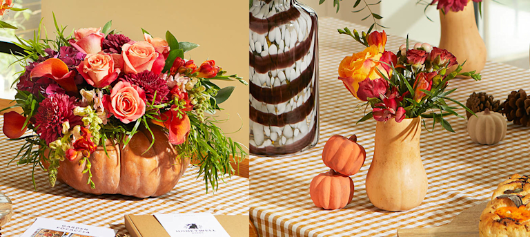 A Halloween dinner party table, featuring flowers artfully arranged in a large orange pumpkin and a smaller pink-and-white squash.