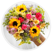 A bouquet of yellow, pink and lilac flowers including sunflowers and dahlias.