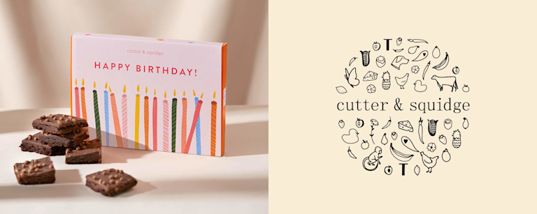 A box of brownies with the message 'Happy birthday!' on, next to Cutter & Squidge's logo.