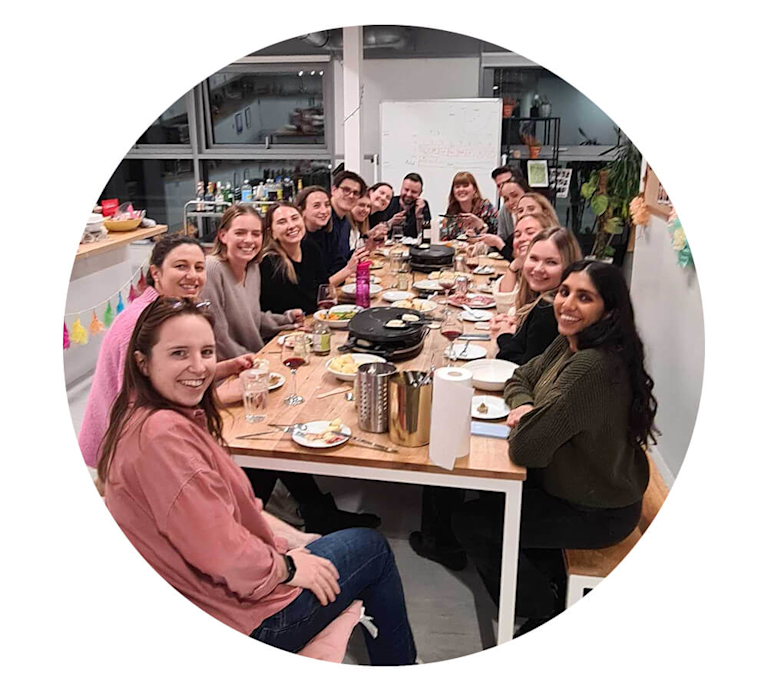 A team of Bloom & Wild employees gathered around a long lunch table in their London HQ