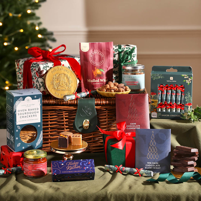 A Bloom & Wild Hamper featuring a gold coin, crackers, chocolate and fudge