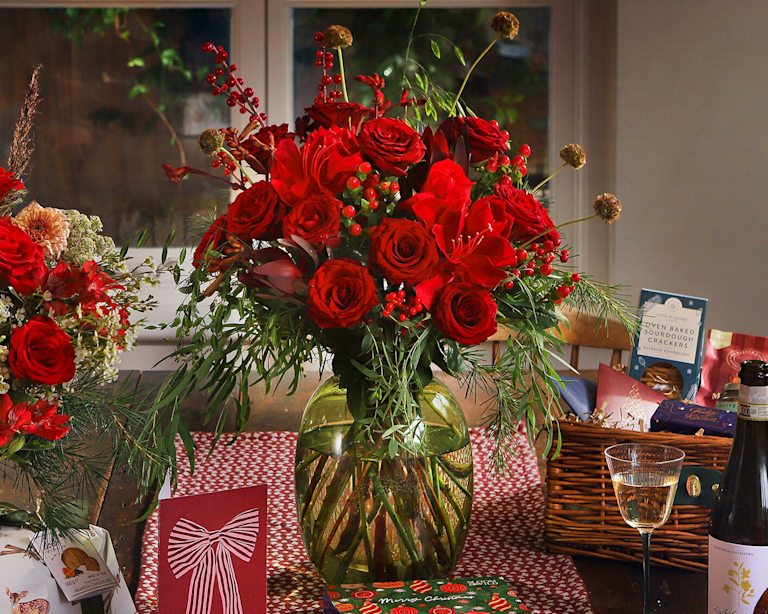 Large red bouquet featuring roses and berries