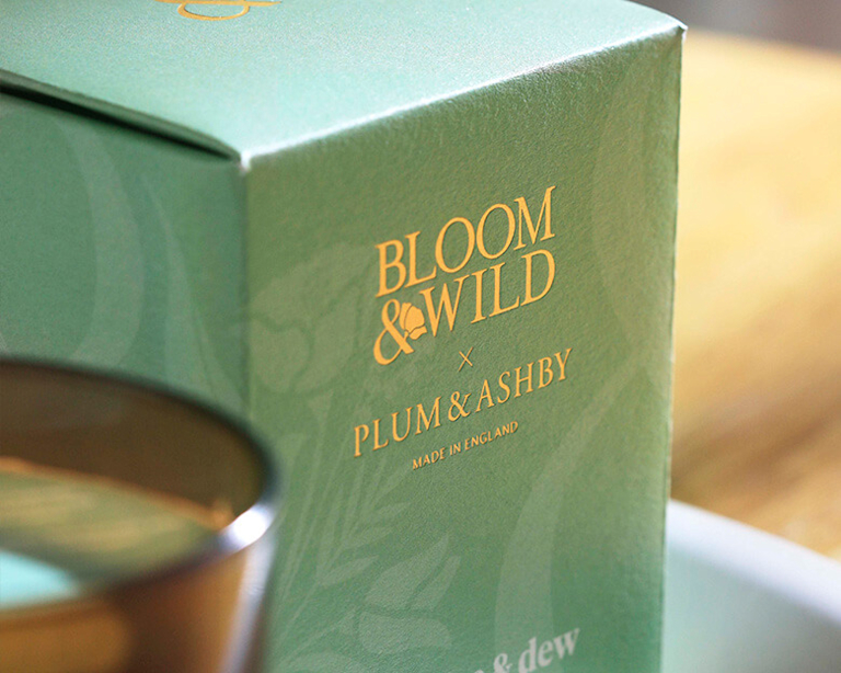 A close up of a Bloom & Wild candle, in its premium-looking packaging.